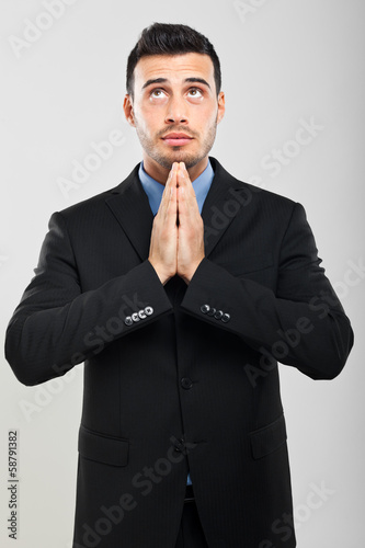 Photo: Businessman praying in supplication Businessman praying in supplication