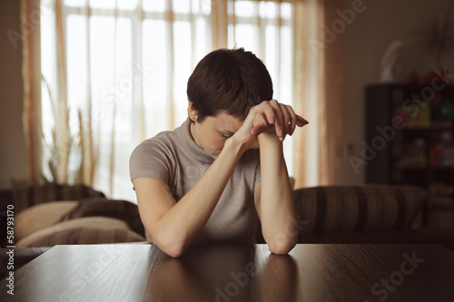 Photo: Pretty young woman sitting and sad Pretty young woman sitting and sad