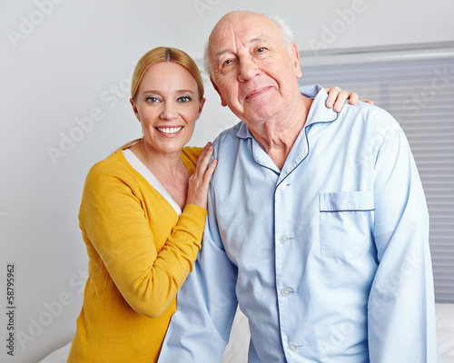 Photo: Caregiver nursing senior man in family Caregiver nursing senior man in family