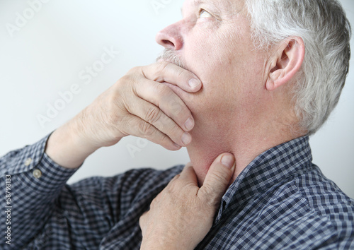 Photo: man with throat or neck problems man with throat or neck problems