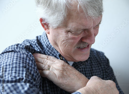 Photo: man suffering from shoulder pains man suffering from shoulder pains