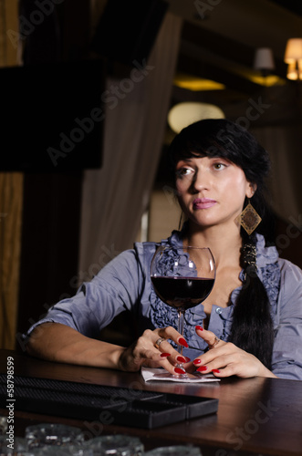 Photo: Sad thoughtful woman drinking at the pub Sad thoughtful woman drinking at the pub