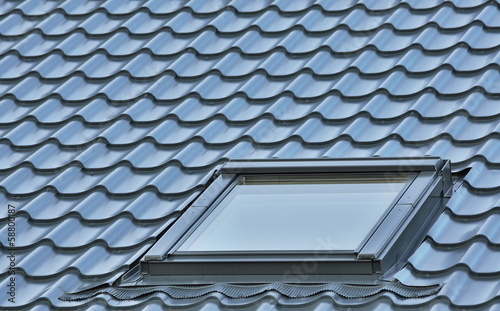 Photo: Roof window on a grey tiled rooftop, large detailed loft skyligh Roof window on a grey tiled rooftop, large detailed loft skyligh