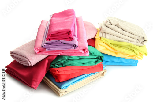 Photo: heap of cloth fabrics isolated on white heap of cloth fabrics isolated on white