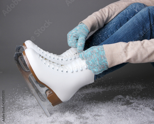 Photo: Skater wearing skates on gray background Skater wearing skates on gray background