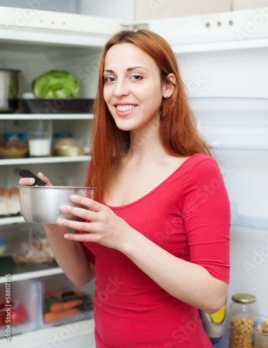 Photo: Happy long-haired woman with pan Happy long-haired woman with pan