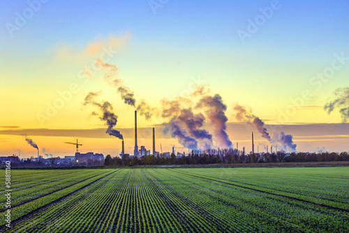 Photo: industry complex in Frankfurt in early morning with green fields industry complex in Frankfurt in early morning with green fields