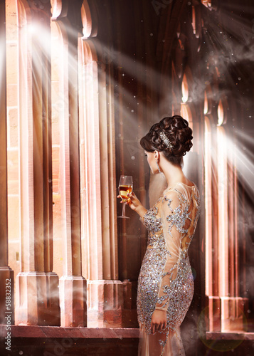 Photo: Woman in Evening Dress with Glass of Champagne in Sunshine Woman in Evening Dress with Glass of Champagne in Sunshine