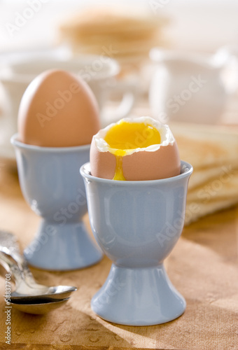 Photo: sunny breakfast table with two soft-boiled eggs. sunny breakfast table with two soft-boiled eggs.