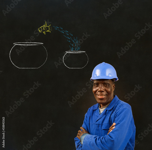 Photo: Black man worker with chalk jumping fish bowls background Black man worker with chalk jumping fish bowls background