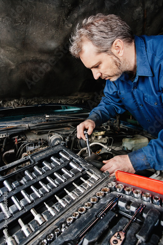 Photo: Mechanic fixing an engine Mechanic fixing an engine