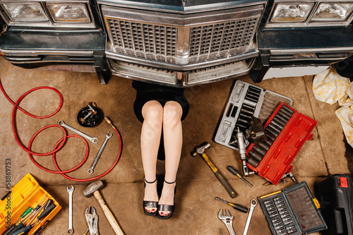 Photo: Woman repairing her car Woman repairing her car
