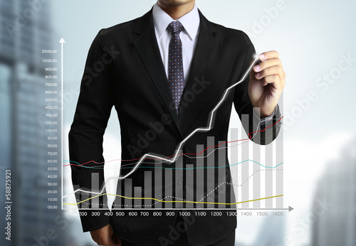 Photo: Business man hand drawing graph Business man hand drawing graph