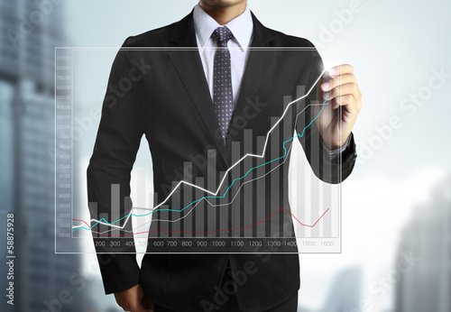 Photo: Business man hand drawing graph Business man hand drawing graph