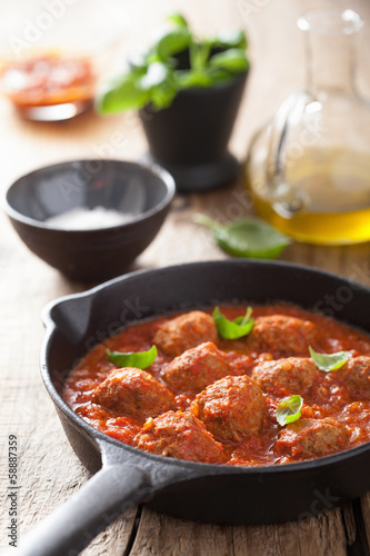 Photo: meatballs with tomato sauce in black pan meatballs with tomato sauce in black pan