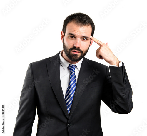 Photo: Businessman making a crazy gesture over white background Businessman making a crazy gesture over white background