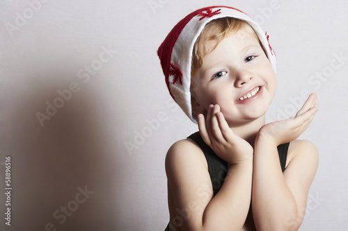 Photo: happy little boy in Santa hat. Christmas. smile happy little boy in Santa hat. Christmas. smile