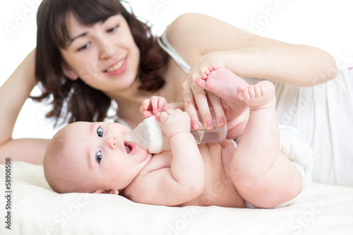 Photo: mother feeding from bottle her adorable baby mother feeding from bottle her adorable baby
