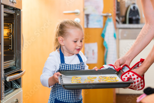 Photo: Mother and daughter baking in kitchen Mother and daughter baking in kitchen