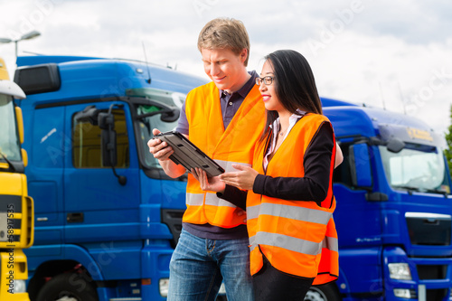 Photo: Forwarder in front of trucks on a depot Forwarder in front of trucks on a depot