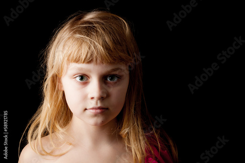Photo: Closeup studio portrait of blond Caucasian little girl on black Closeup studio portrait of blond Caucasian little girl on black