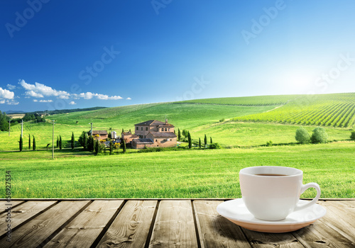 Photo: cup coffee and tuscany landscape, Italy cup coffee and tuscany landscape, Italy