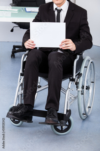 Photo: Handicapped Businessman Holding Paper Handicapped Businessman Holding Paper