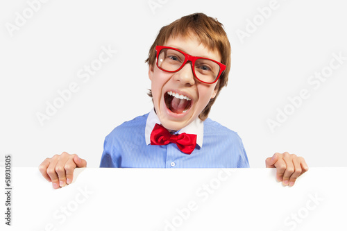 Photo: Boy in red glasses holding white square Boy in red glasses holding white square