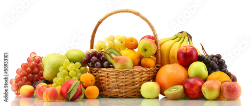 Photo: Assortment of exotic fruits in basket isolated on white Assortment of exotic fruits in basket isolated on white