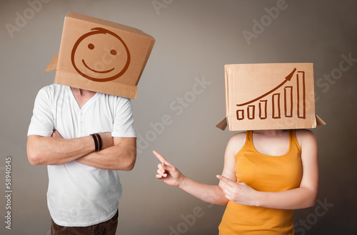 Photo: Handsome men in suit gesturing with drawn charts on box Handsome men in suit gesturing with drawn charts on box