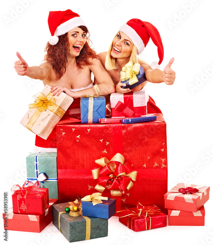 Photo: Girl in Santa hat holding Christmas gift box. Girl in Santa hat holding Christmas gift box.