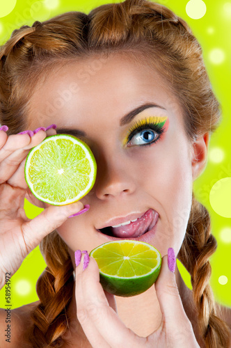 Photo: Beautiful woman holds lime in her hands Beautiful woman holds lime in her hands