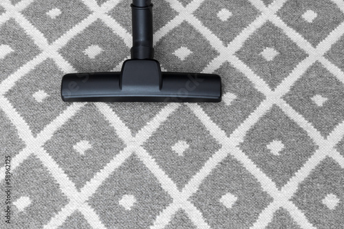 Photo: Vacuum cleaner on gray carpet Vacuum cleaner on gray carpet