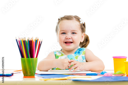Photo: happy kid drawing with pencils happy kid drawing with pencils