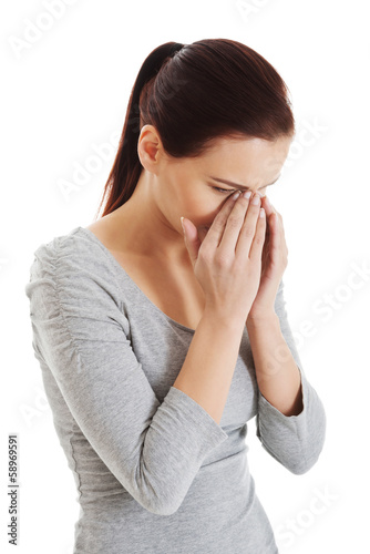 Photo: Young beautiful woman touching her nose. Young beautiful woman touching her nose.