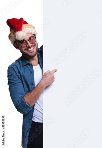 Photo: santa man is presenting a blank board santa man is presenting a blank board