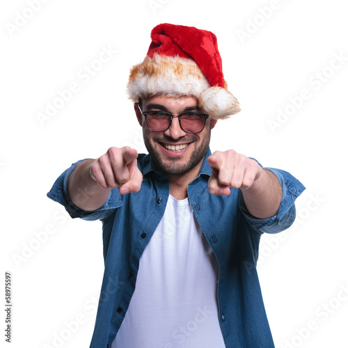 Photo: man in santa hat is pointing his fingers man in santa hat is pointing his fingers