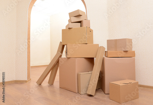 Photo: Empty room with stack of cartons: moving house concept Empty room with stack of cartons: moving house concept
