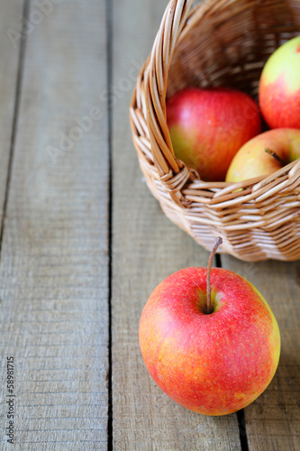 Photo: Fresh red and yellow apple and a basket Fresh red and yellow apple and a basket