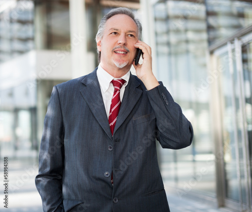 Photo: Businessman talking on the phone Businessman talking on the phone