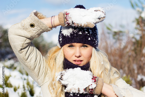 Photo: beautiful winter woman playing with snow beautiful winter woman playing with snow