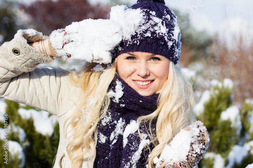 Photo: beautiful winter woman playing with snow beautiful winter woman playing with snow