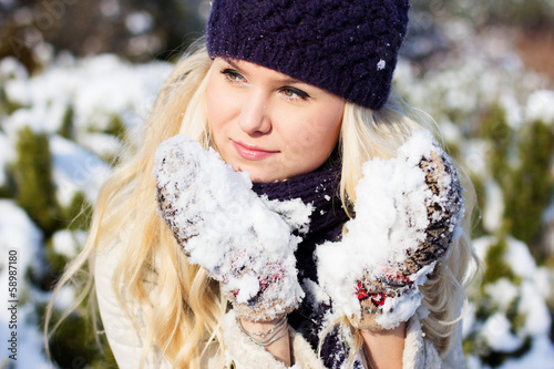Photo: beautiful winter woman playing with snow beautiful winter woman playing with snow