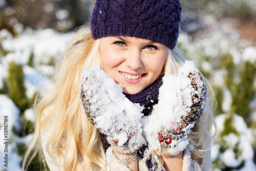 Photo: beautiful winter woman playing with snow beautiful winter woman playing with snow