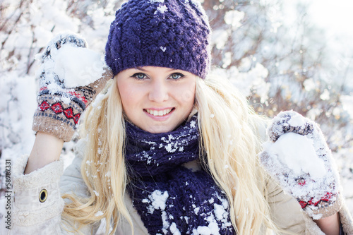 Photo: beautiful winter woman playing with snow beautiful winter woman playing with snow