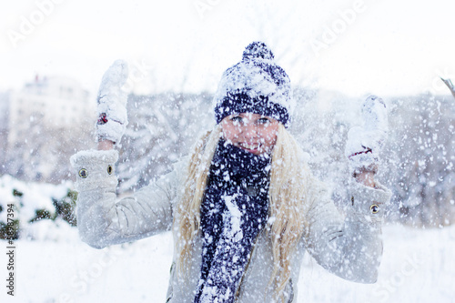 Photo: beautiful winter woman playing with snow beautiful winter woman playing with snow