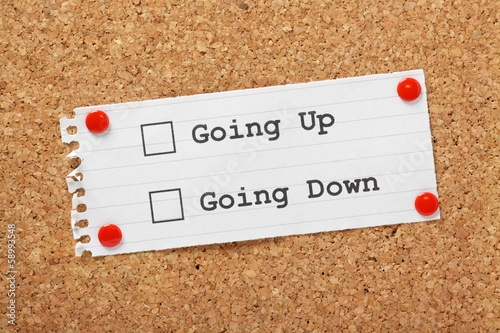 Photo: Going Up or Down Tick Boxes on a cork notice board Going Up or Down Tick Boxes on a cork notice board