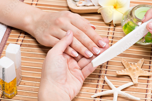 Photo: Woman in a nail salon receiving manicure Woman in a nail salon receiving manicure