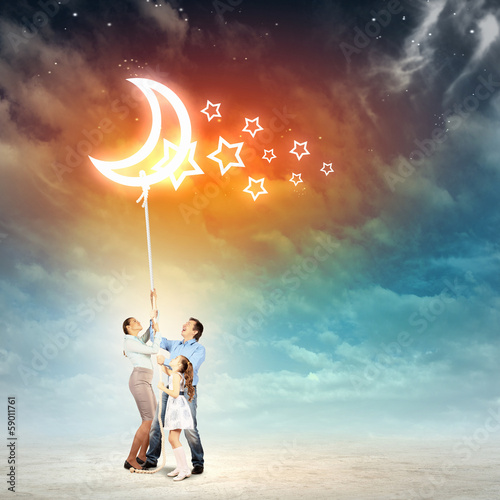 Photo: Family pulling rope with a moon Family pulling rope with a moon
