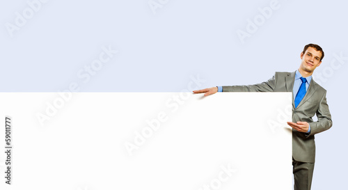 Photo: Businessman holding blank banner Businessman holding blank banner